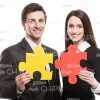 Business Partners With Red And Yellow Pieces Of Puzzle Stock Photo