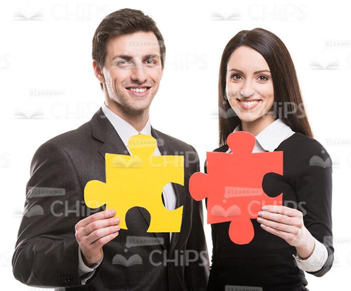 Business Partners With Red And Yellow Pieces Of Puzzle Stock Photo