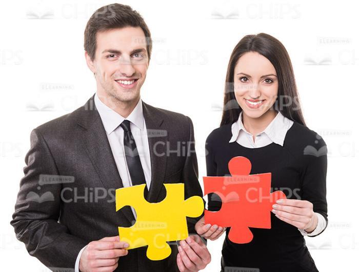 People Showing Pieces Of Puzzle Stock Photo