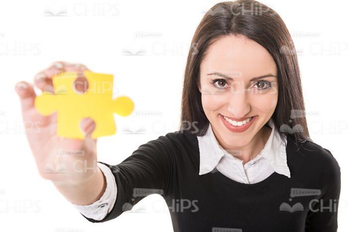 Young Lady With Yellow Jigsaw Puzzle Stock Photo