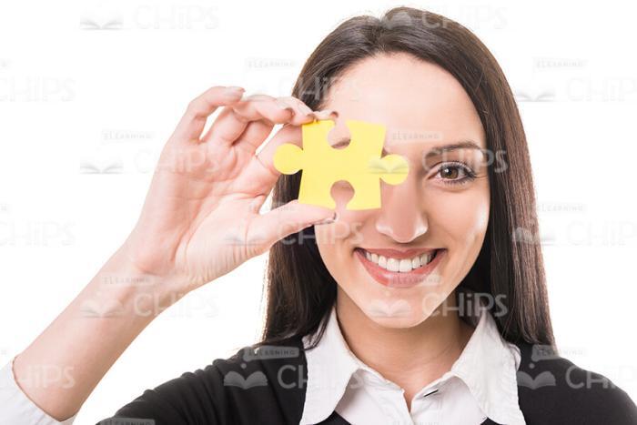 Lady Covering Her Eye With Yellow Piece Of Puzzle Stock Photo