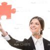 Young Woman Raising Up Red Colored Piece Of Puzzle Stock Photo