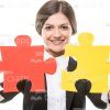 Successful Businesswoman Holds Two Pieces Of Puzzle Stock Photo