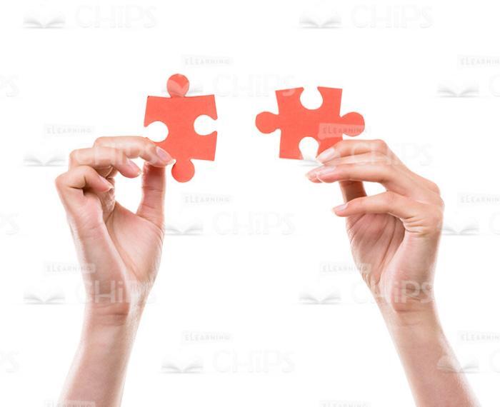 Hands Holding Small Red Jigsaw Pieces Stock Photo