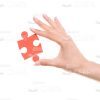Woman's Hand With Jigsaw Puzzle Stock Photo