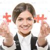 Smiling Businesslady Presenting Small Jigsaw Puzzles Stock Photo