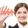 Smiling Woman Showing Her Jigsaw Puzzle Stock Photo