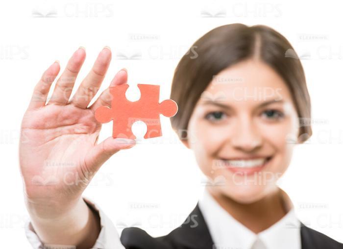 Smiling Woman Showing Her Jigsaw Puzzle Stock Photo