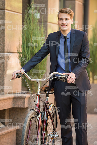 Young Businessman With Bicycle Stock Photo