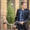 Confident Businessman Walking With Bicycle Stock Photo