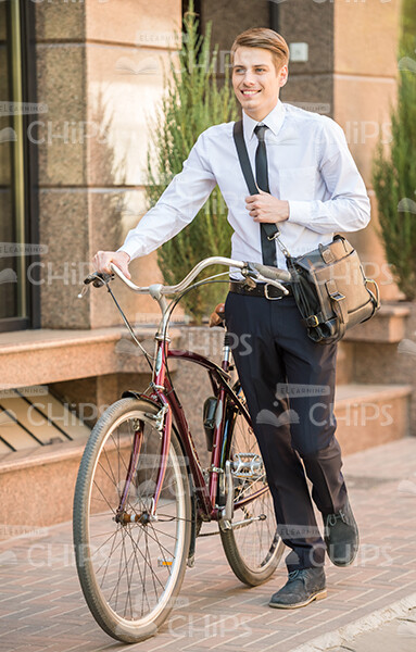 Happy Business Man Holding His Bike Stock Photo