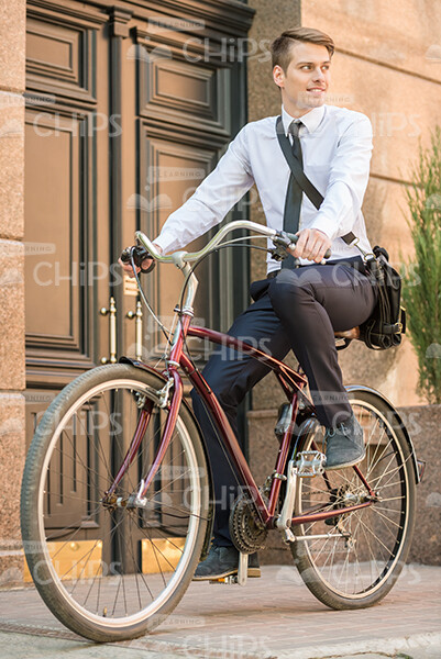 Good-Looking Young Guy In Classic Clothes Riding On Bike Stock Photo