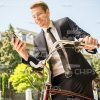 Nice Businessman Using Phone And Going To Ride On Bicycle Stock Photo