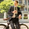 Confident Young Man Leaning On Bike Stock Photo