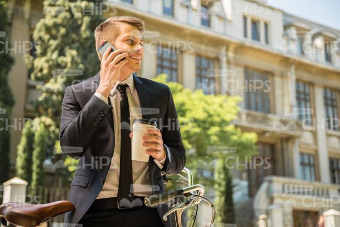Man Talking The Phone And Holding Coffee Cup Stock Photo