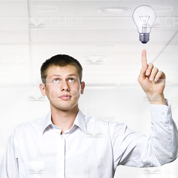 Young Man Has An Idea And Pointing On Lightbulb Stock Photo