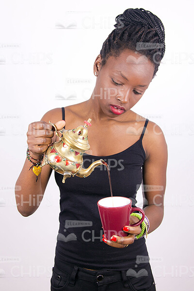 African Woman Pouring Tea Stock Photo-0