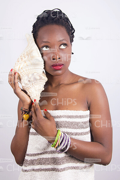 African Woman Holding Large Sea Shell Stock Photo-0