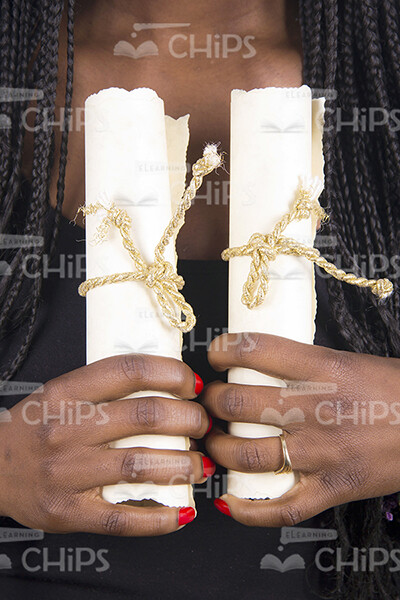 Woman's Hands Holding Two Scrolls Stock Photo-0