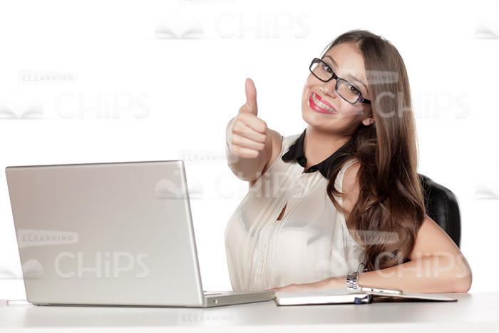 Excited Business Lady Sitting At Table And Showing Thumb Up Stock Photo-0