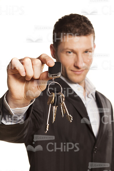 Slightly Smiling Businessman Holding Keys Stock Photo-0