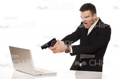 Businessman Aiming Gun At Laptop Stock Photo-0