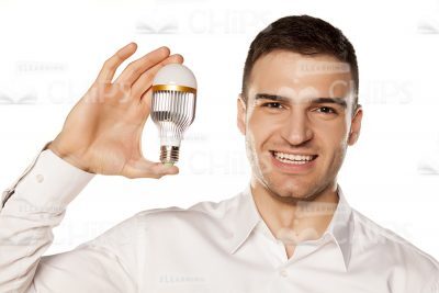 Smiling Young Businessman Holding Light Bulb Stock Photo-0