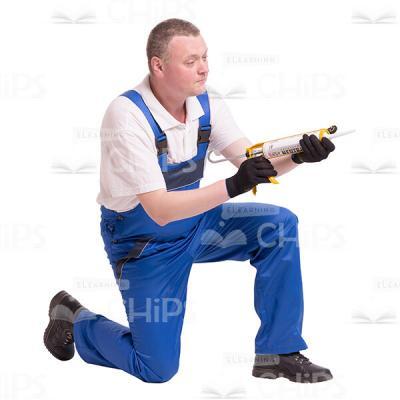 Cutout Image of Mid-Aged Worker with Construction Syringe Gun Standing on His Right Knee -0