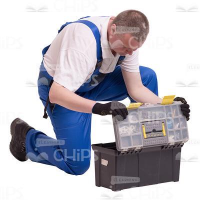 Middle-aged Constructor Sorting Instruments in His Toolbox Cutout Photo-0