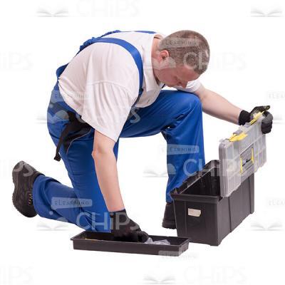 Middle-aged Builder Kneeling Unpacked a Toolbox Cutout Photo-0