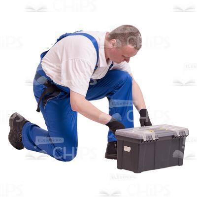 Middle-aged Builder Kneeling Closed a Toolbox Cutout Photo-0