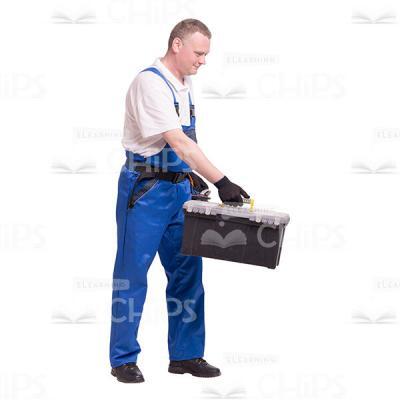 Cutout Photo of Middle-aged Constructor Standing Sideways and Giving a Toolbox to Someone-0