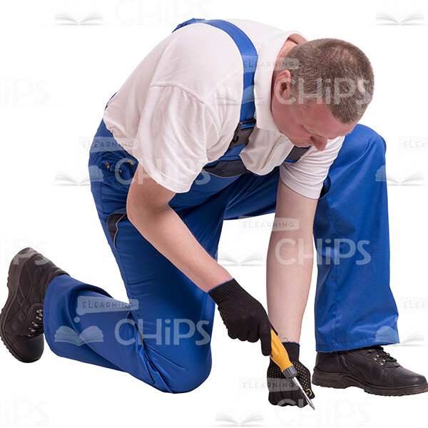 Cutout Photo of Middle-aged Builder Kneeling and Unscrewing a Nut-0