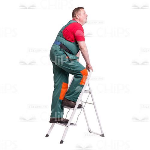 Middle-Aged Repairman Going up the Steps of the Folding Ladder and Looking up Cutout Picture-0