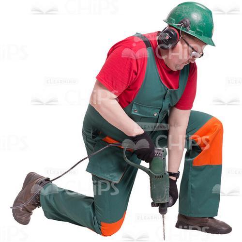 Cutout Picture of Middle-age Builder Kneeling and Drilling Holes in the Floor-0
