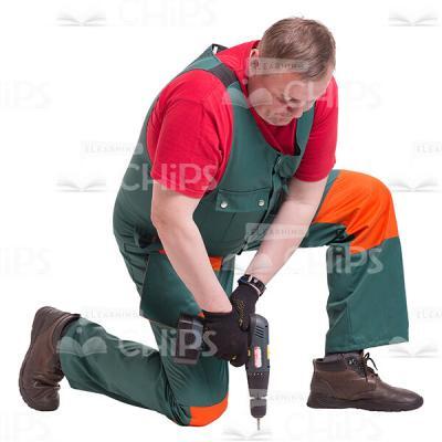 Repairman On One Knee Drilling In The Floor Cutout Picture-0
