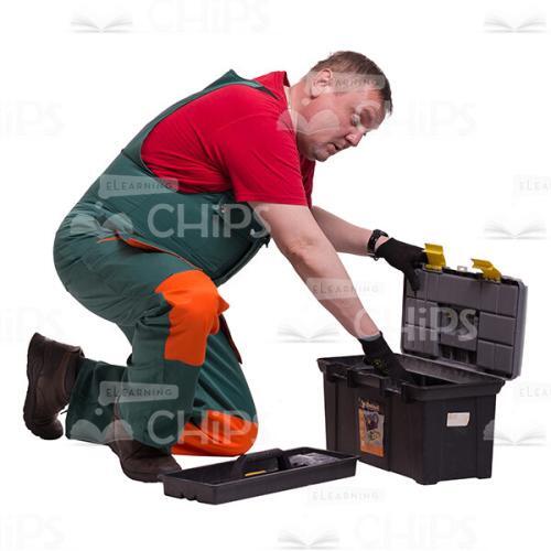 Middle-aged Repairman Looking Into The Instrument Box Cutout Picture-0