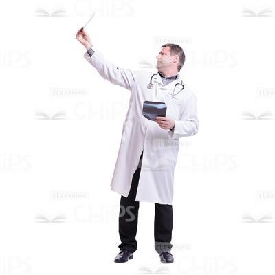 Doctor Raising And Looking At The Roentgen Cutout Photo-0