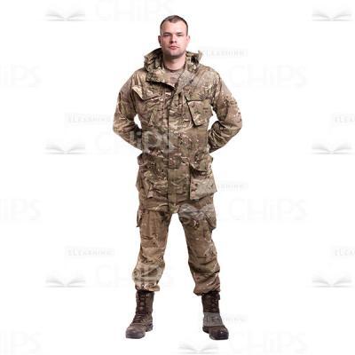 Young Soldier Standing With The Crossed Behind The Back Hands In The Camouflage Cutout Photo-0