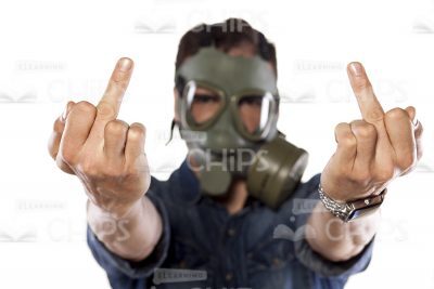 Stock Photo Of Young Man In Gas Mask Showing Middle Fingers Gesture-0