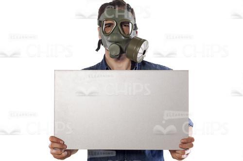 Young Man Wearing Gas Mask And Holding Board Stock Photo-0