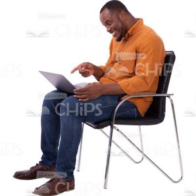 Smiling Cutout Man Sitting On Chair With Computer Points Index Finger-0
