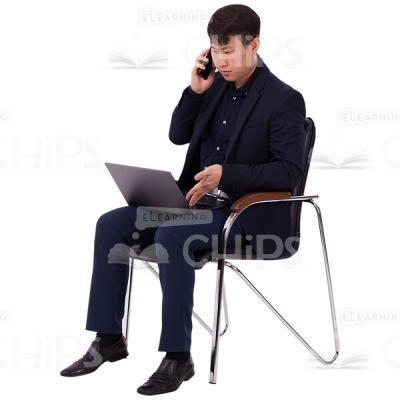 Asian Man Sitting And Working With Computer And Phone Image Cutout-0